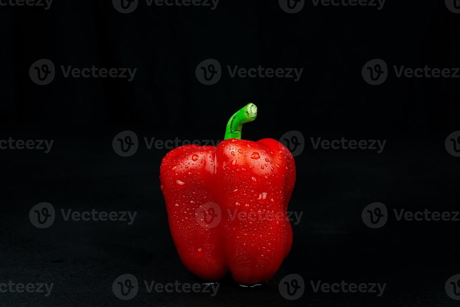 natural red pepper on black background photo