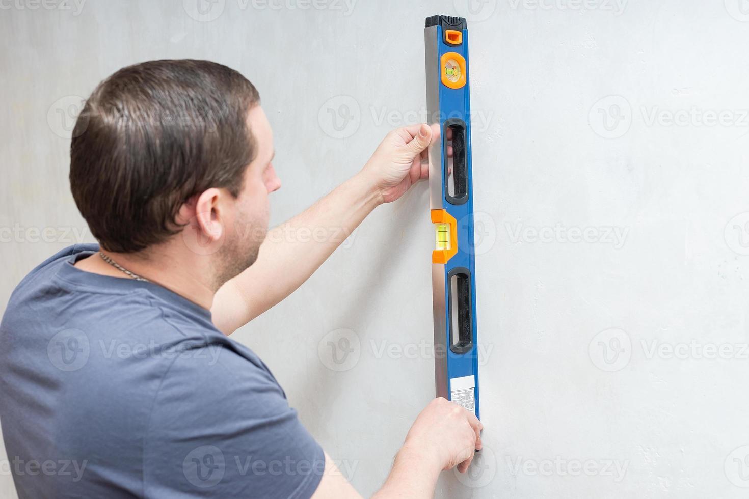 builder with a level in his hands photo