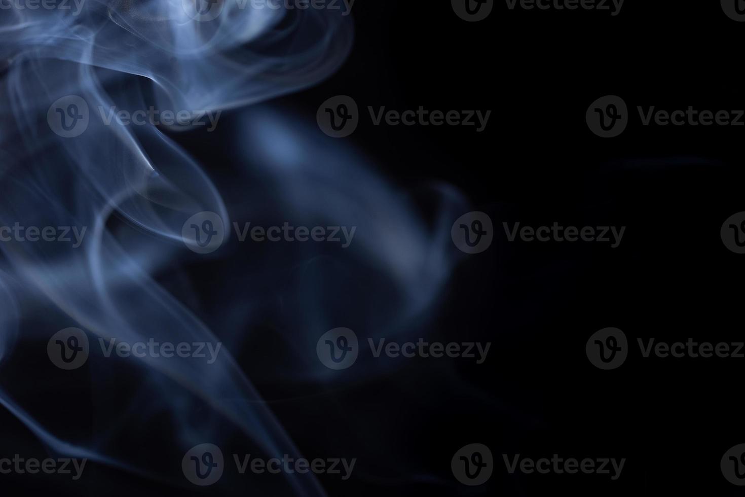 Movement of white smoke isolated on black background. photo