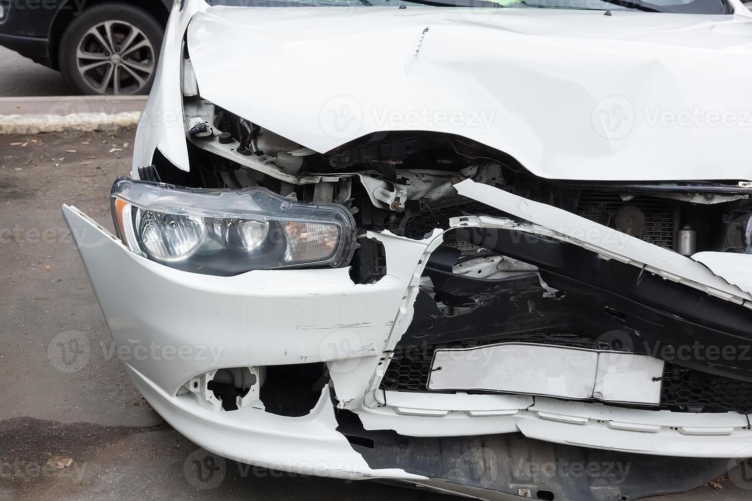 Front of black car get damaged by accident on the road photo