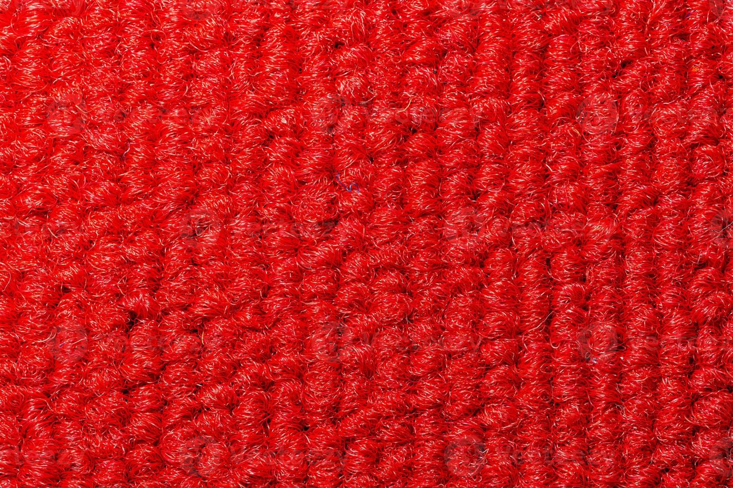 Seamless close up of monochrome red carpet texture background from above. photo