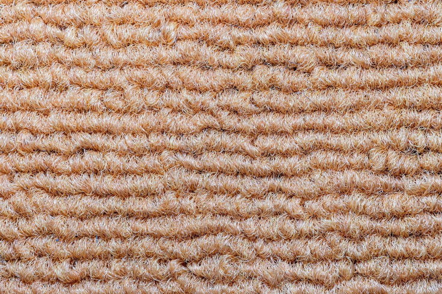 Seamless close up of monochrome beige carpet texture background from above. photo