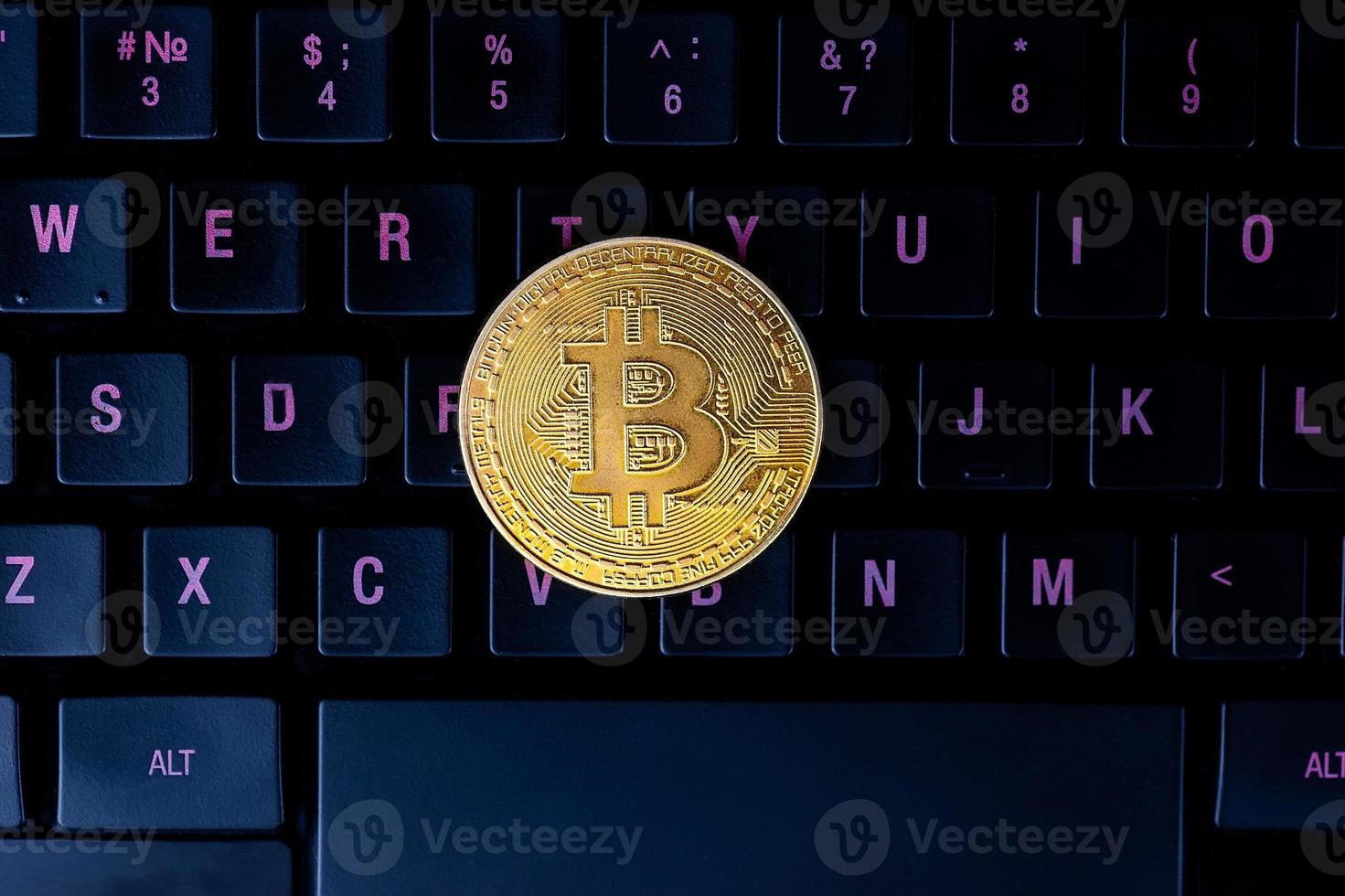 gold bitcoin on the keyboard. photo