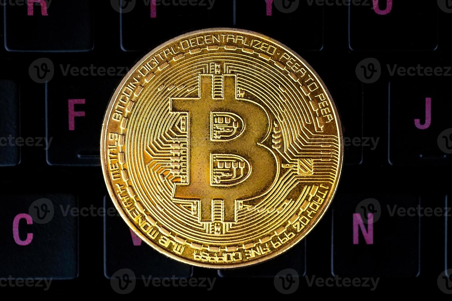 gold bitcoin on the keyboard. photo