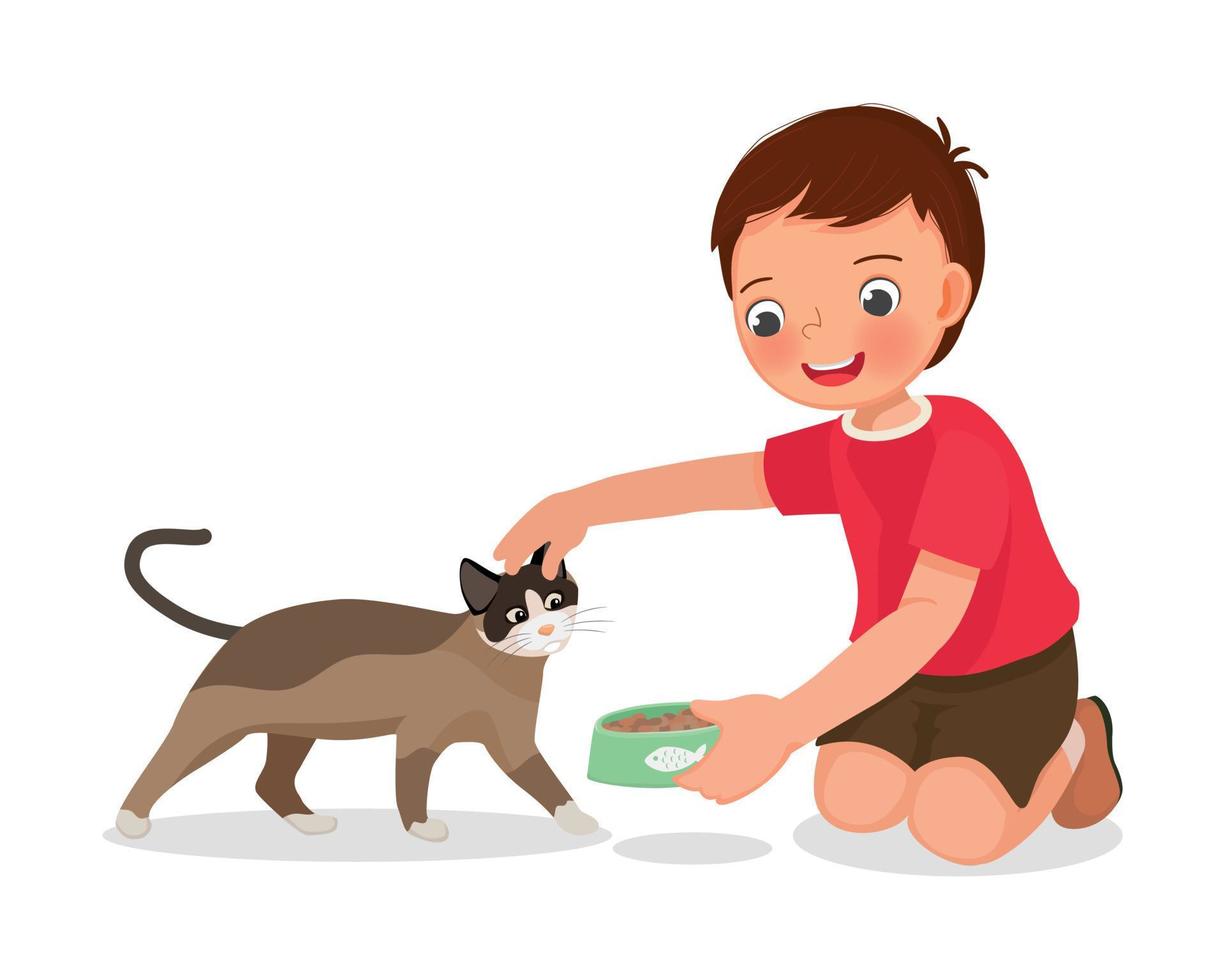 Cute little boy feeding his pet cat with animal food at home vector