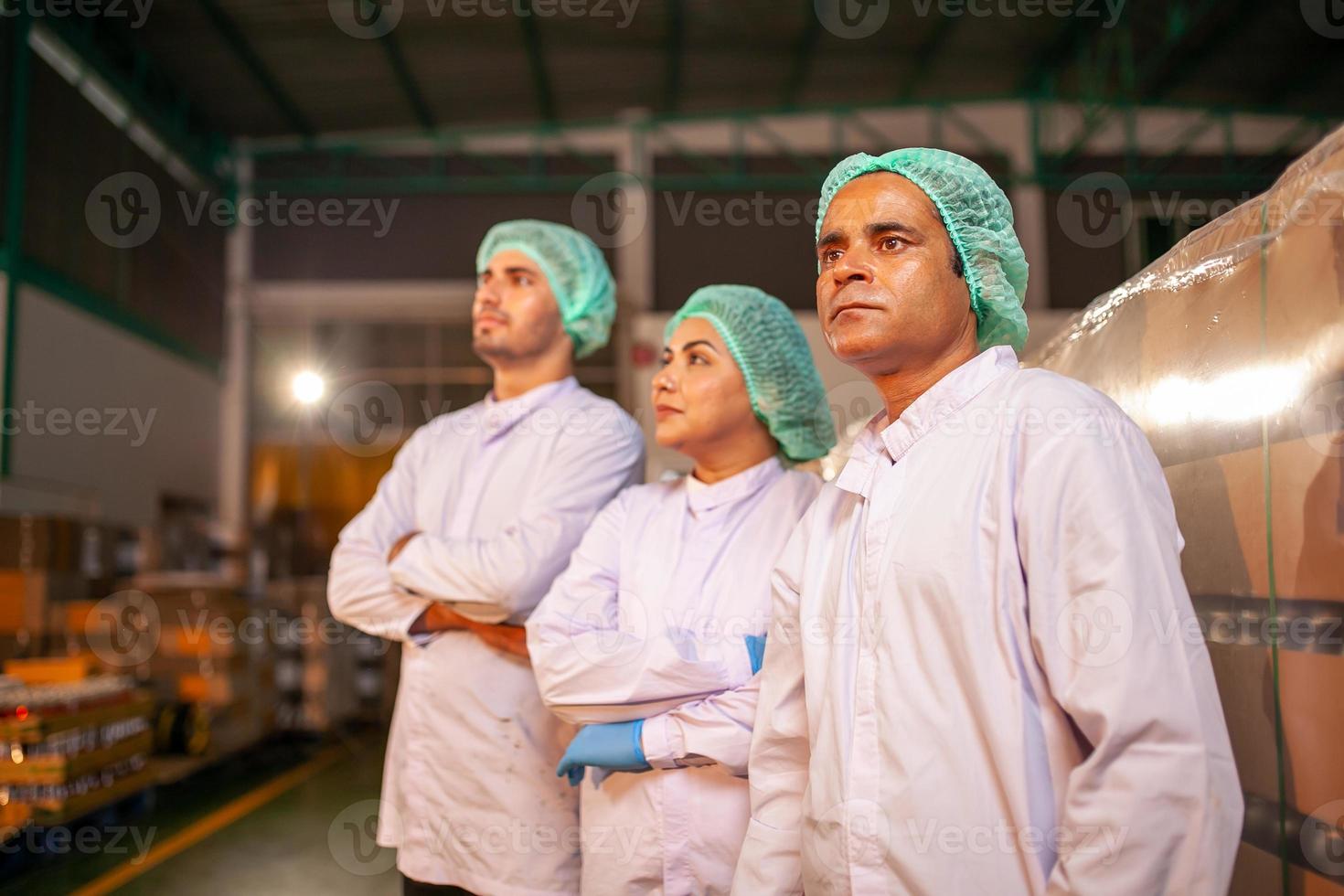 worker team on the production line in the beverage factory. Manufacturer checks quality of food industry. photo