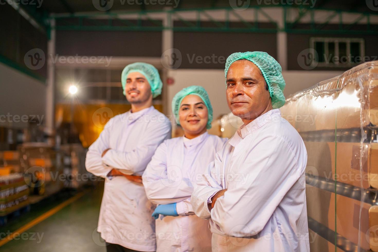 worker team on the production line in the beverage factory. Manufacturer checks quality of food industry. photo