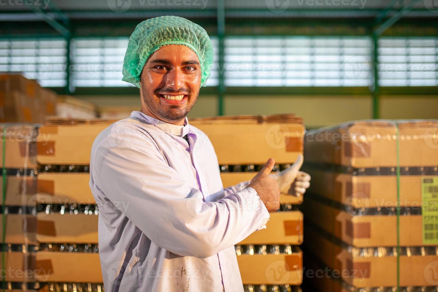 worker presenting products on the production line in the beverage factory. Manufacturer checks quality of food industry. photo