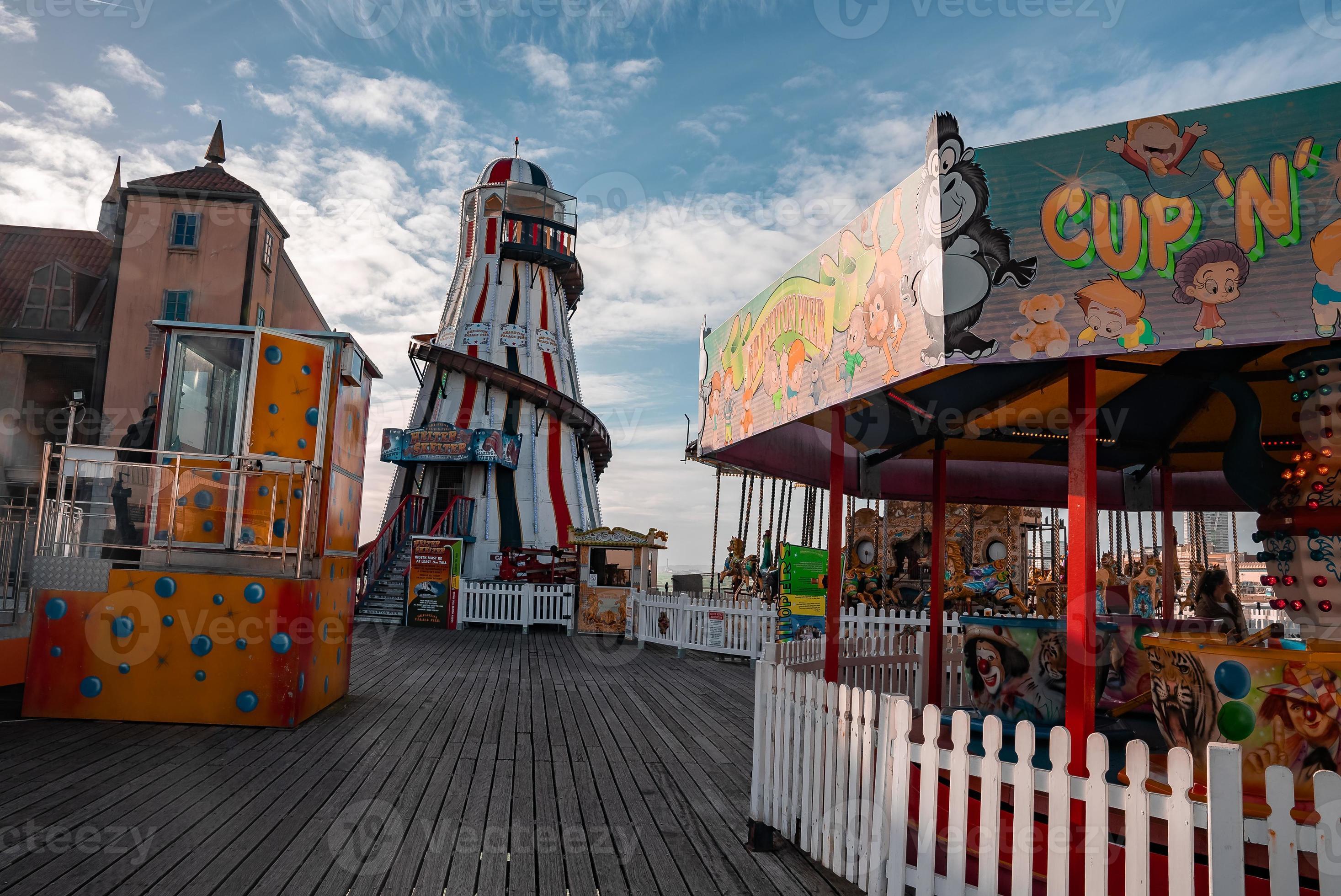 Holiday makers on roller coasters and rides at the amusement park on