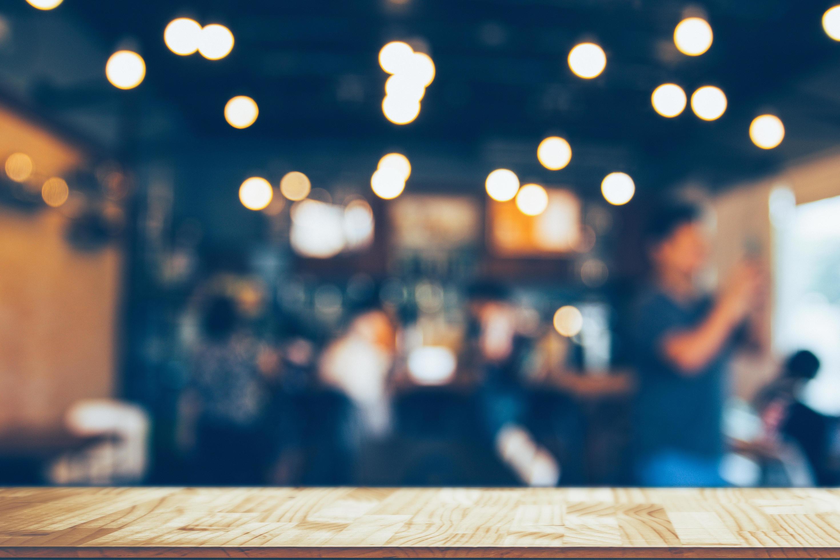 Image of wooden table in front of abstract blurred restaurant lights  background 13433339 Stock Photo at Vecteezy