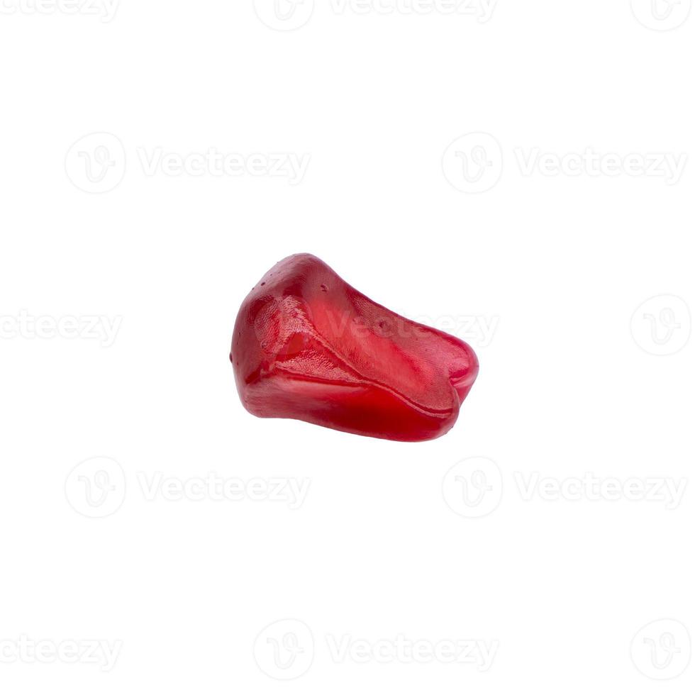 Single macro closeup of red color pomegranate seed shape isolated on white background photo