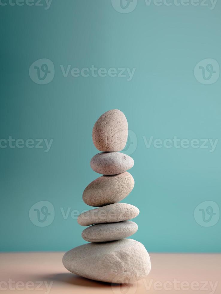 Natural Pebble Stone Stack. Metaphor of Balancing Body, Mind, Soul and Spirit. Mental Health Practice. Harmony, Calm, Mind, Life Relaxing and Living by Nature Concept. Vertical image photo
