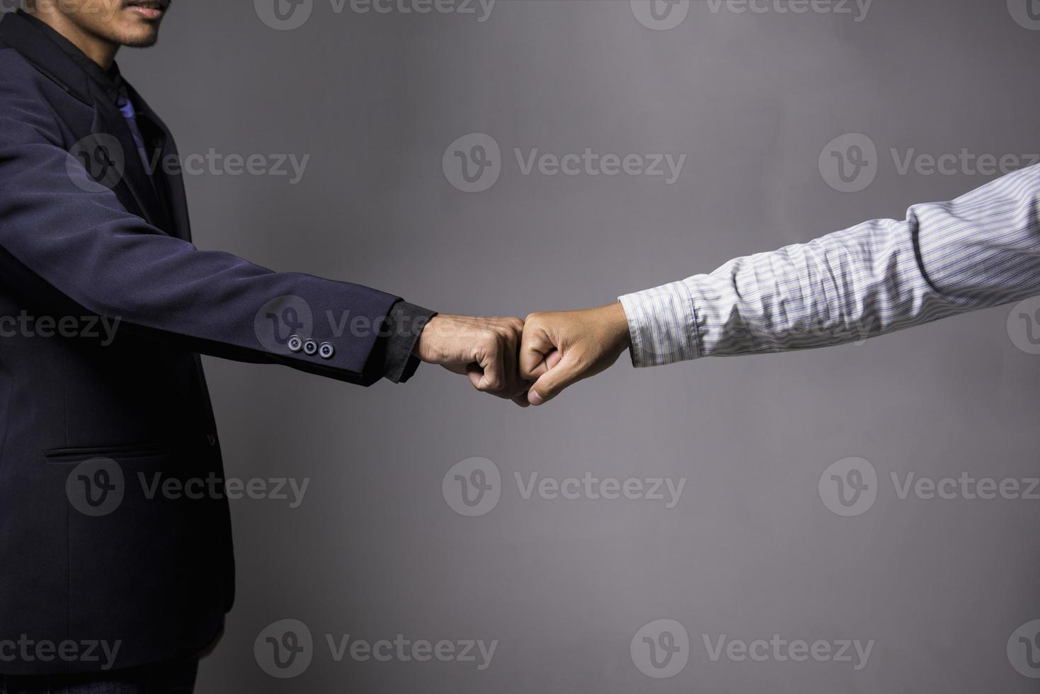Two confident businessman shook hands during office meetings. photo