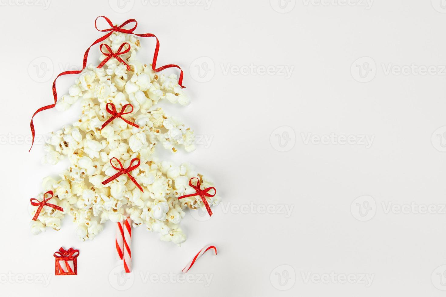 Christmas tree decorations with popcorn on white photo