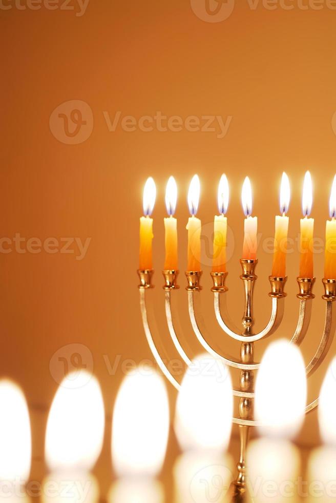 Hanukkah Menorah with Yellow Candles on Yellow Background photo