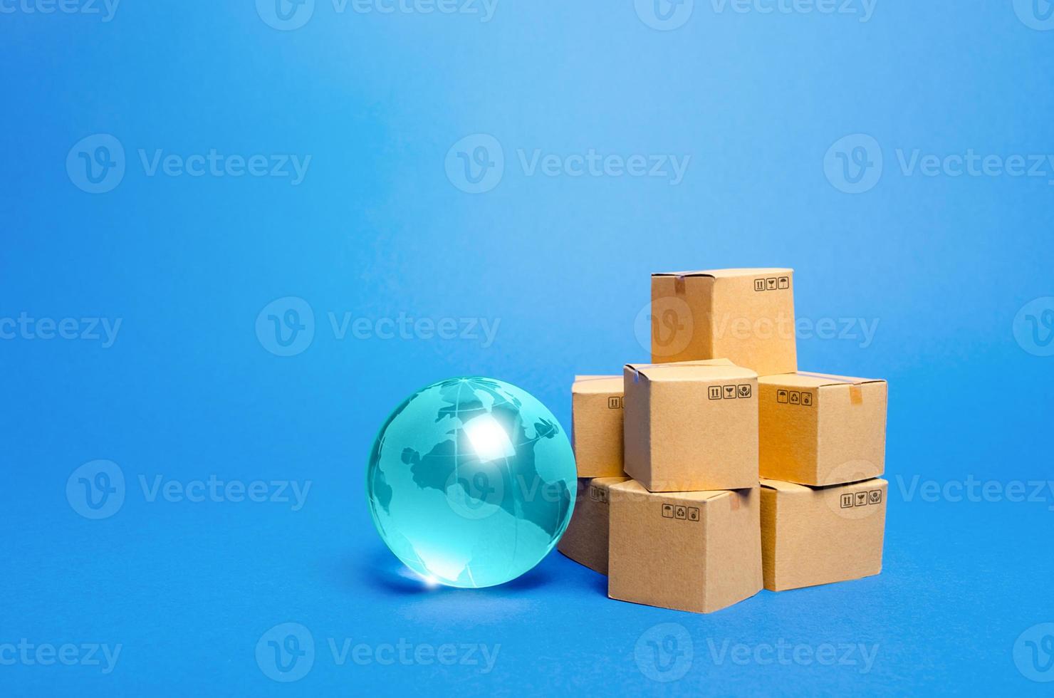Blue glass globe and cardboard boxes. International world trade distribution. Delivery of goods, shipping. Global economy, import export freight traffic. Globalization markets. Economics development. photo