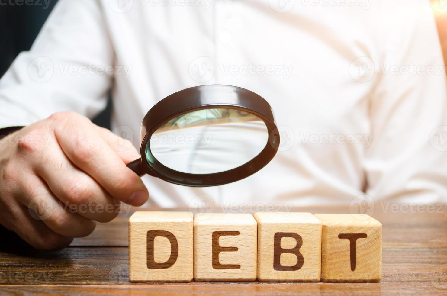 Businessman explores debt. Study of the structure of debt, restructuring and the abolition of penalties, illegal charges. Inability to pay the debt. Unprofitable terms of business lending photo
