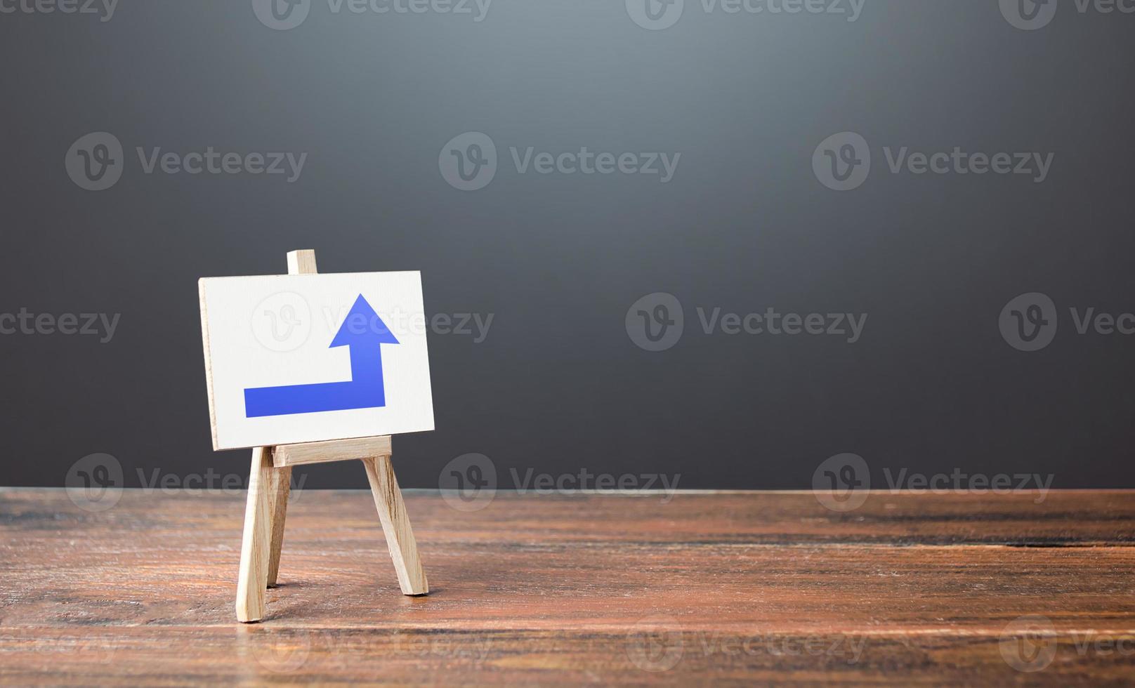 Easel with a blue right up arrow. Direction to go around. Bypassing obstacles and solving problems. Alternative way, fallback. To attract attention. Advertising sign, marketing. Copy space photo