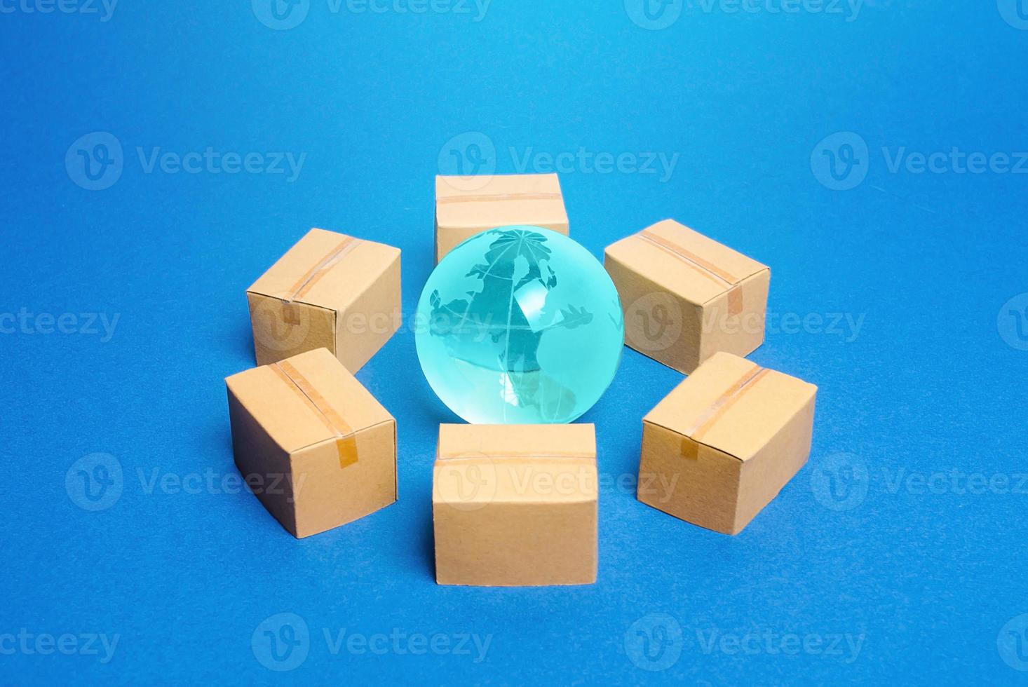 Earth globe is surrounded by boxes. Global business and transportation of goods and products. Shipping and freight, world trade and economics. Distribution, import export. commodity turnover photo
