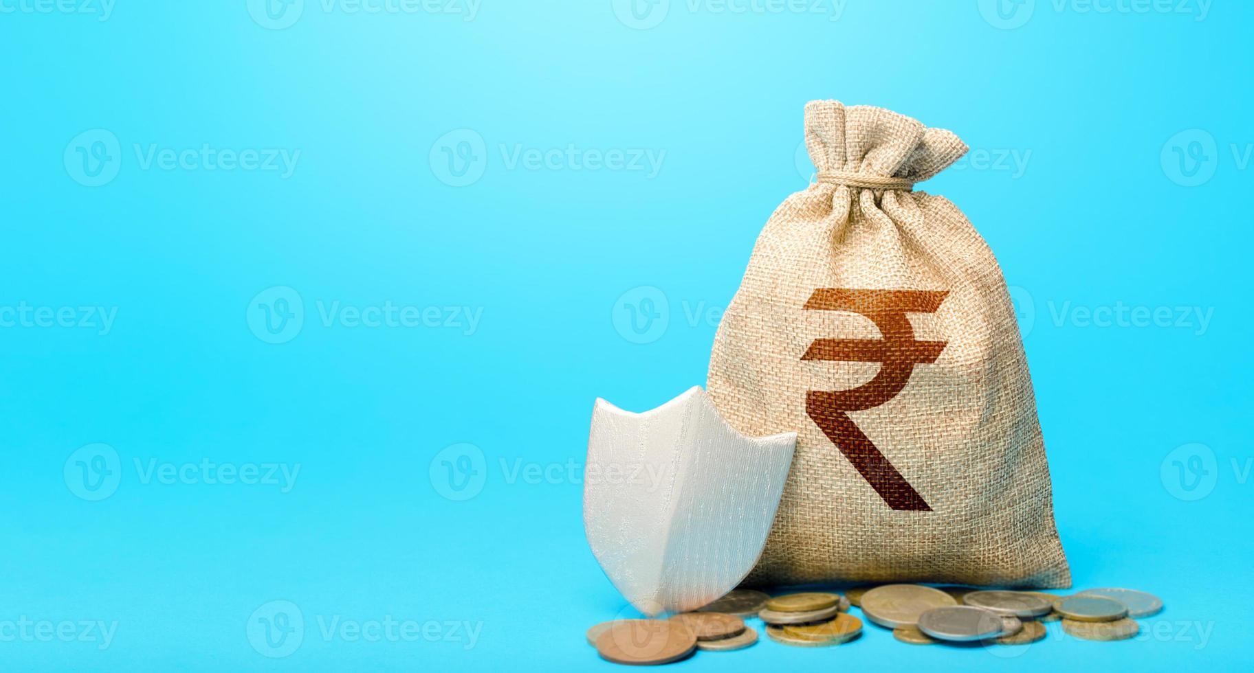 Indian rupee money bag and protection shield. Avoiding loss of funds during inflation. Financial instruments. Guarantee protection savings and investments. Secured loan. Ease doing business. photo