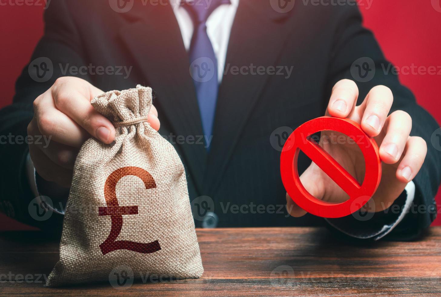 Man refuses to give out british pound sterling money bag. Financial difficulties. Economic sanctions, confiscation of funds. Refusal to provide a loan, bad credit history. Asset freeze seizure. photo