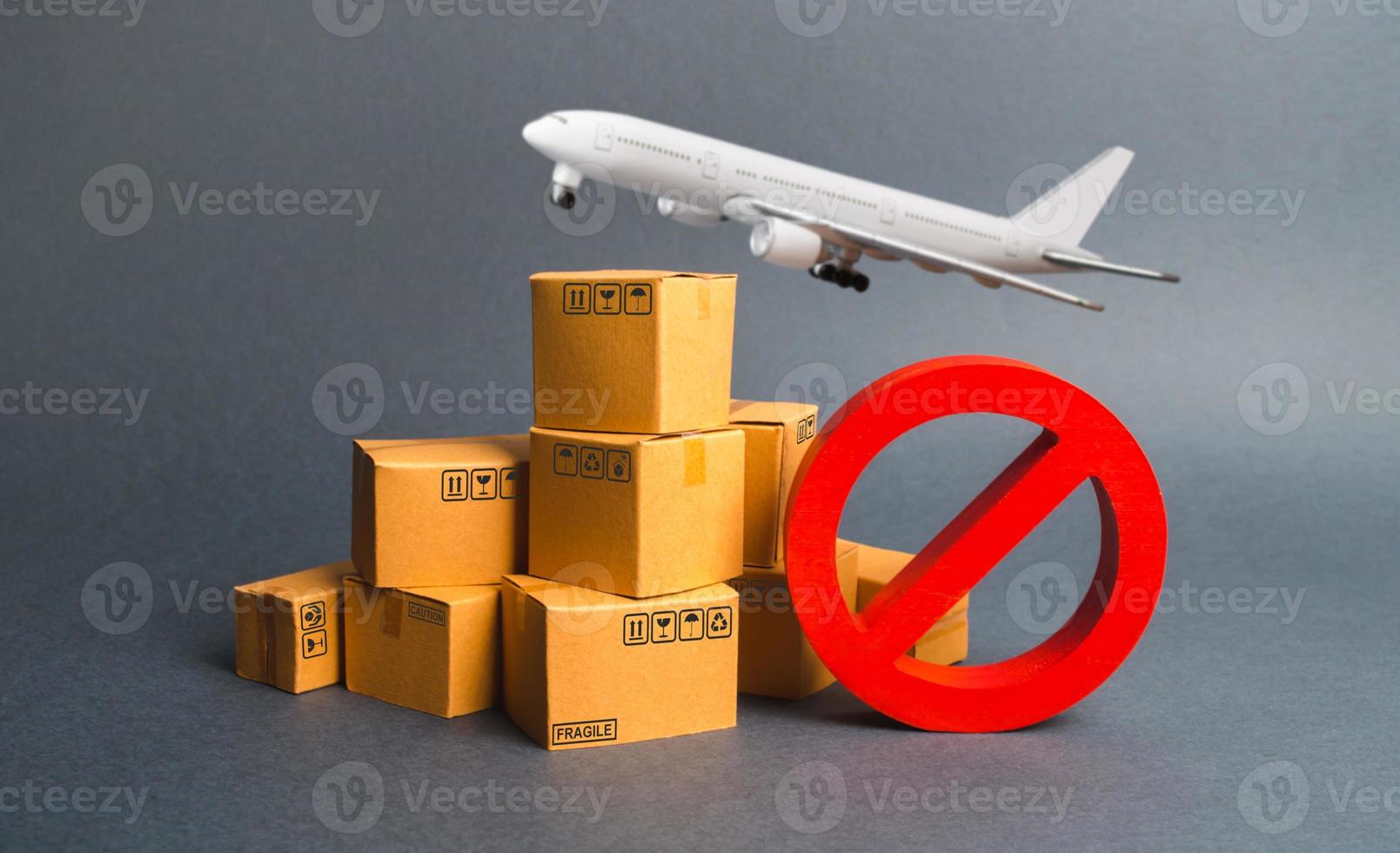Cargo plane, many boxes and red prohibition symbol NO. Embargo trade wars. Restriction on importation, ban transit export dual-use goods to countries under sanctions. transport companies. photo