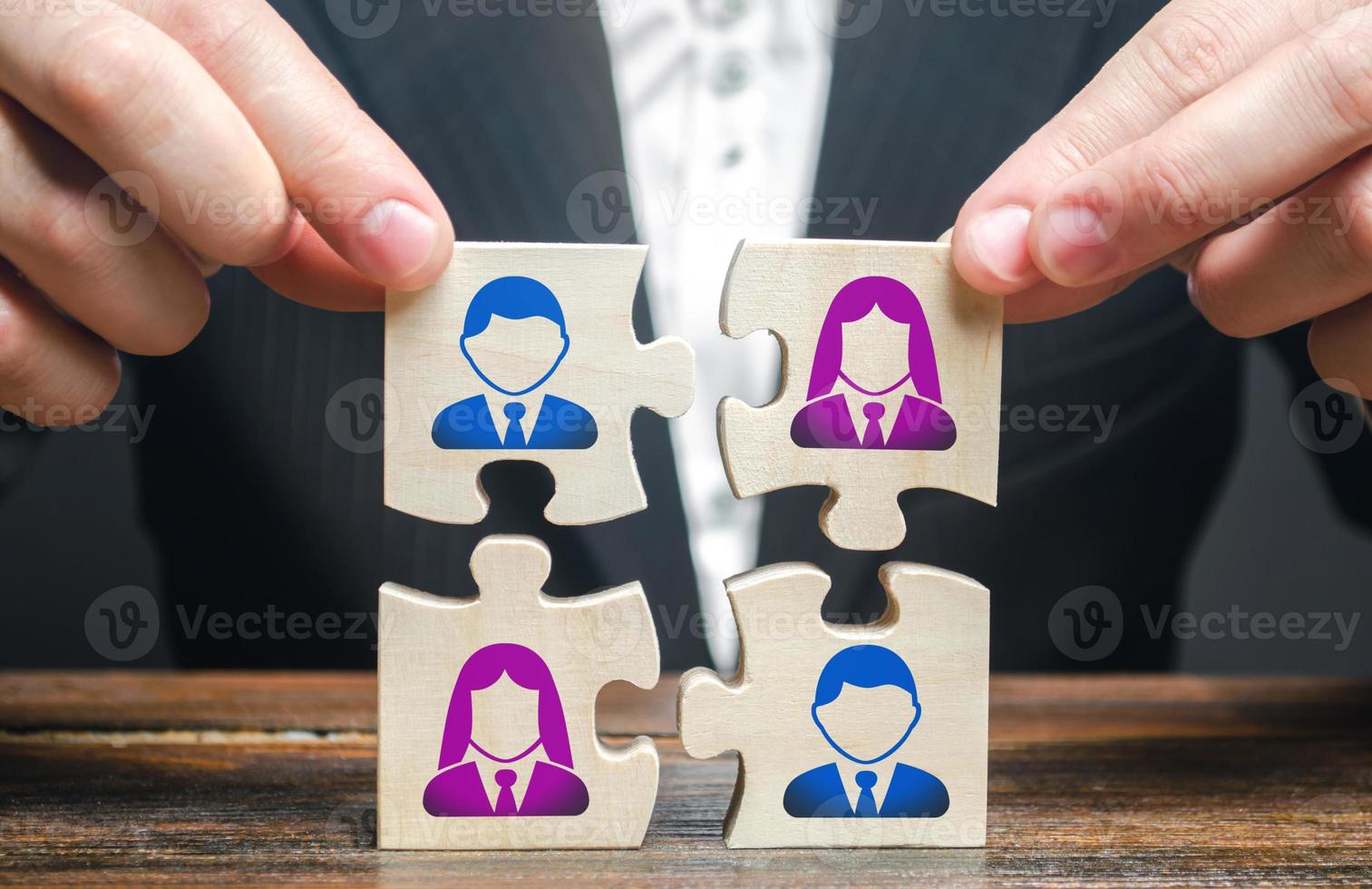 Businessman assembles a team in the form of a set of puzzles. Search, hiring and recruitment staff. Creating an efficient and productive business unit. Leadership and teamwork. Managerial qualities. photo