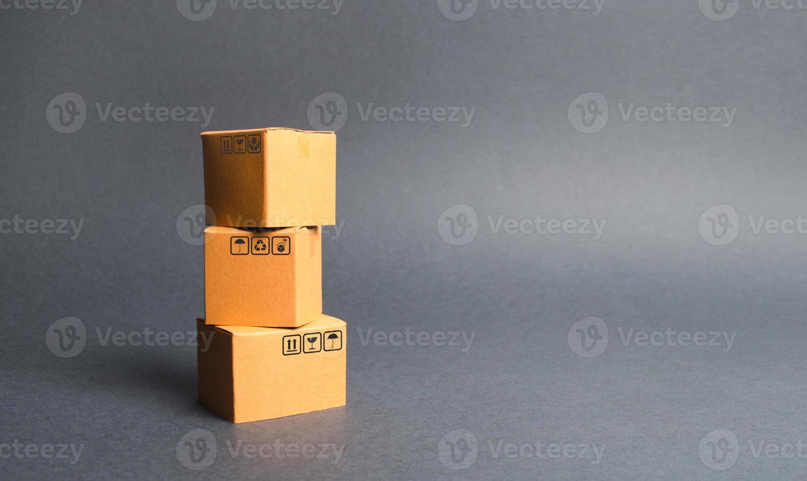 A bunch of three cardboard boxes. The concept of products and goods, commerce and retail. E-commerce, sales and sale of goods through online trading platform. Import and export of products photo