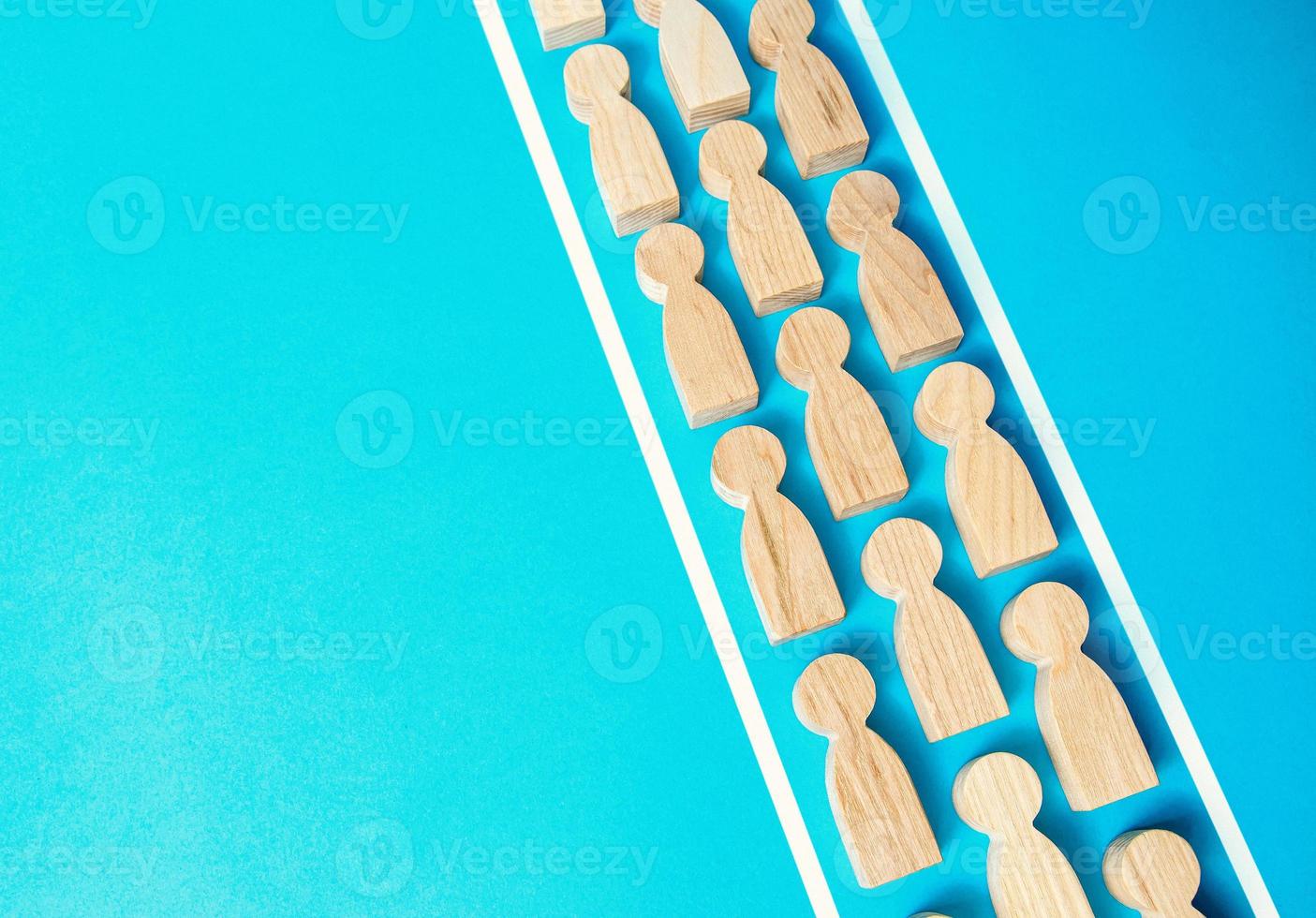 A chain of people within the boundaries of the lines. Concept of conformism, control and obedience. Unchanging course of development. Authoritarianism and despotism. Control of the human masses. photo