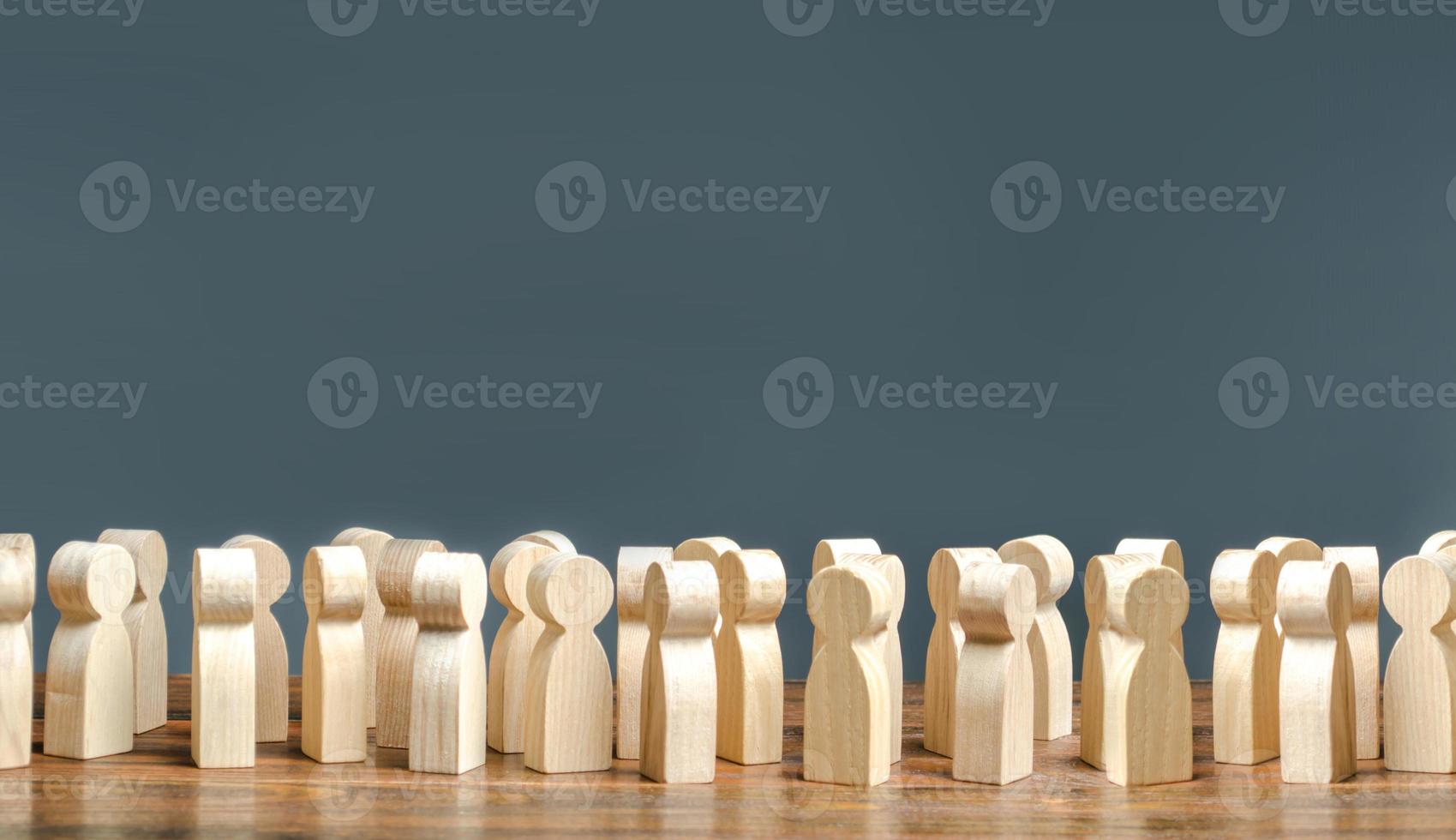 A crowd of wooden figures of people. society, demography. group of citizens, rally, political movement or electorate. Customers and buyers, statistics, preferences of Population. Employees. Copy space photo