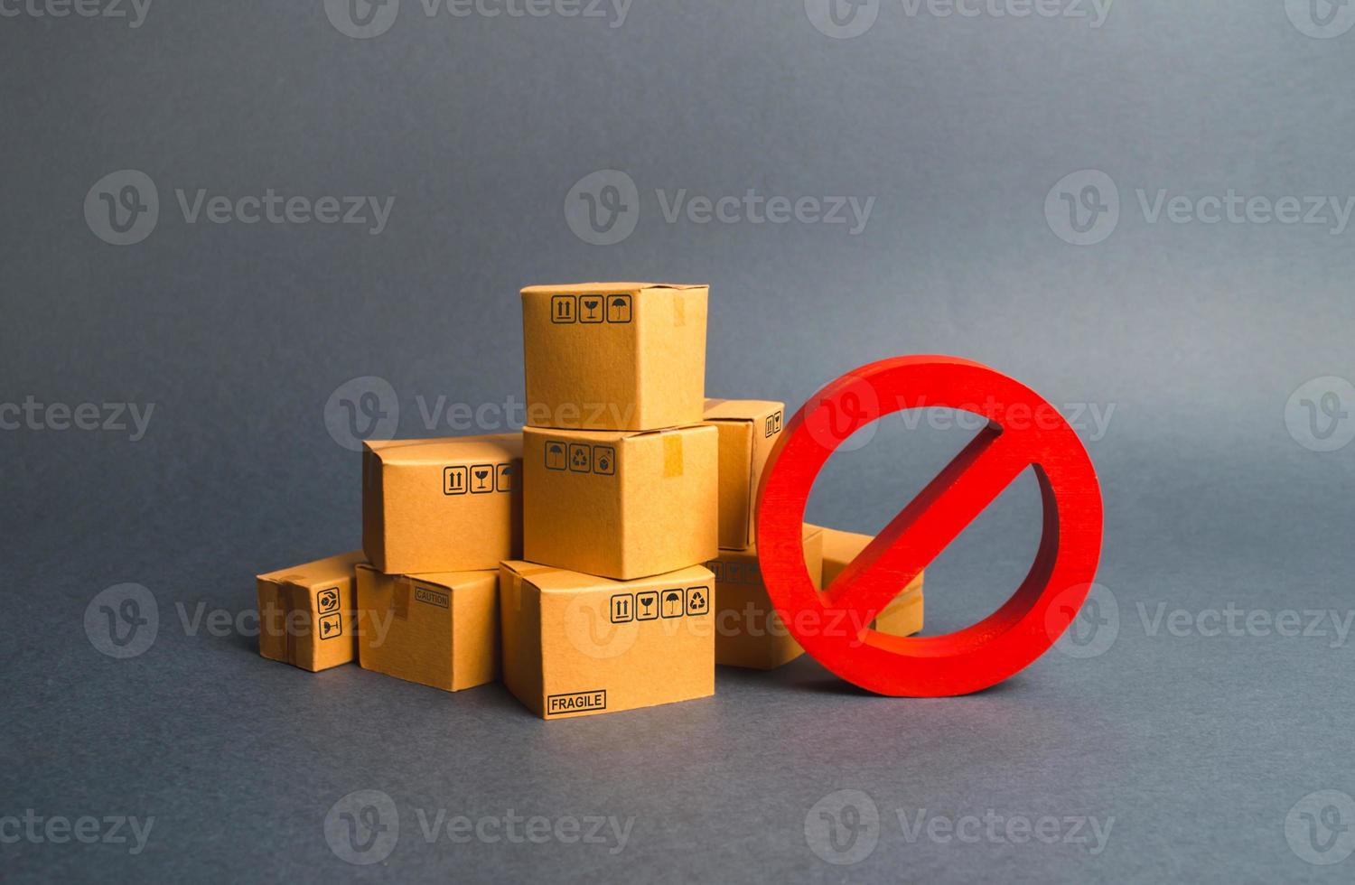 Many cardboard boxes and a red symbol NO. Embargo, trade wars. Restriction on the importation of goods, proprietary for business. Inability to sell products, ban on the import. No delivery. photo