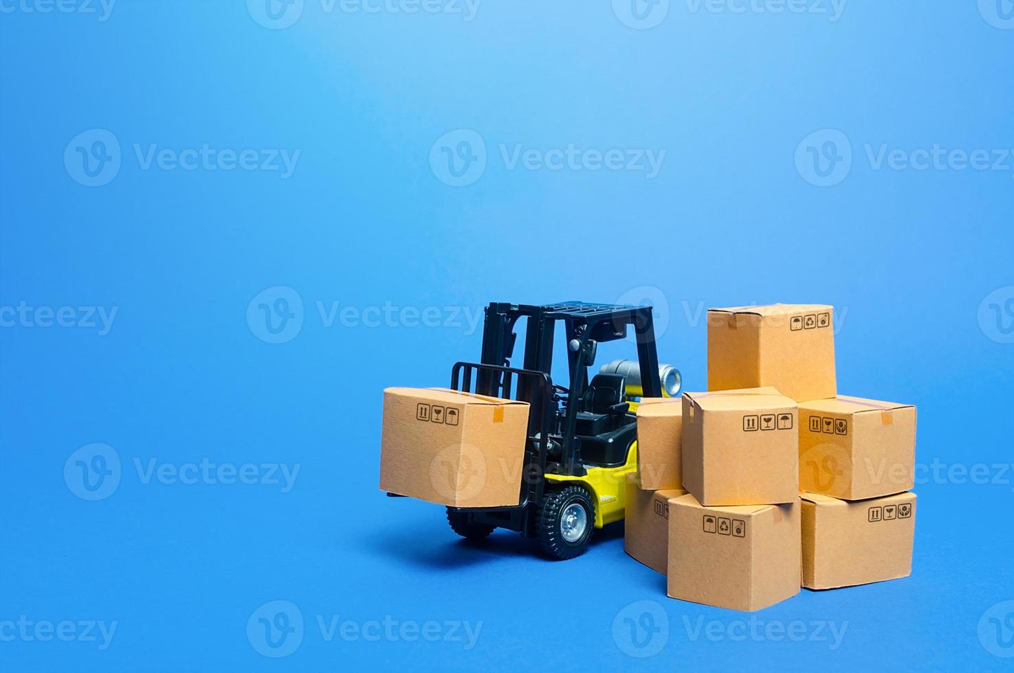 Forklift truck with cardboard boxes. Transportation logistics infrastructure, import and export goods and products delivery. Production, transport, cargo storage. Freight shipping. retail photo