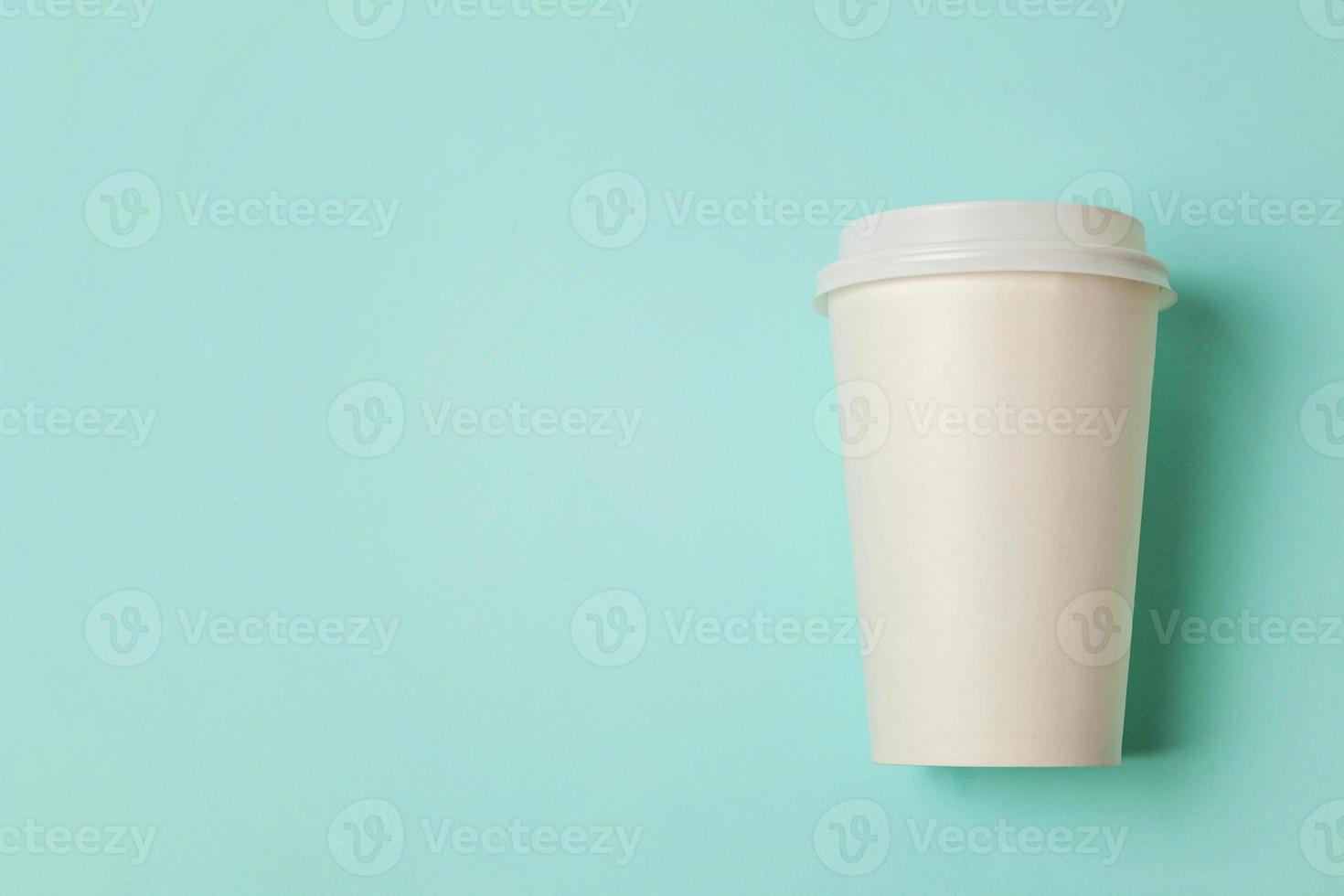 Simply flat lay design paper coffee cup on blue pastel colorful trendy background. Takeaway drink container. Good morning wake up awake concept. Template of drink mockup. Top view copy space. photo