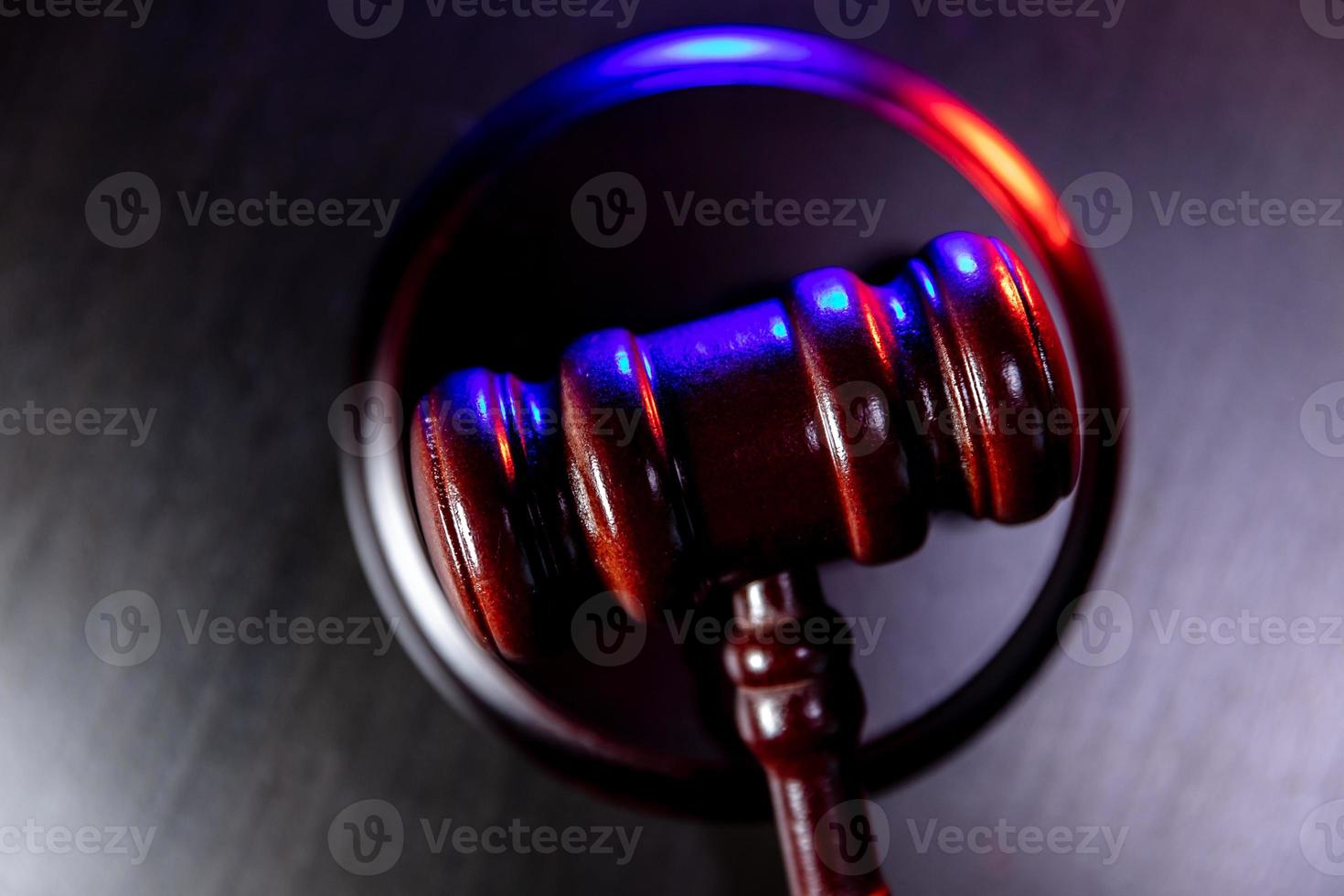 Law theme. Court of law trial in session. Judge gavel on wooden table with police emergency services light. Mallet of judge on dark background. Justice human rights concept. Copy space. photo