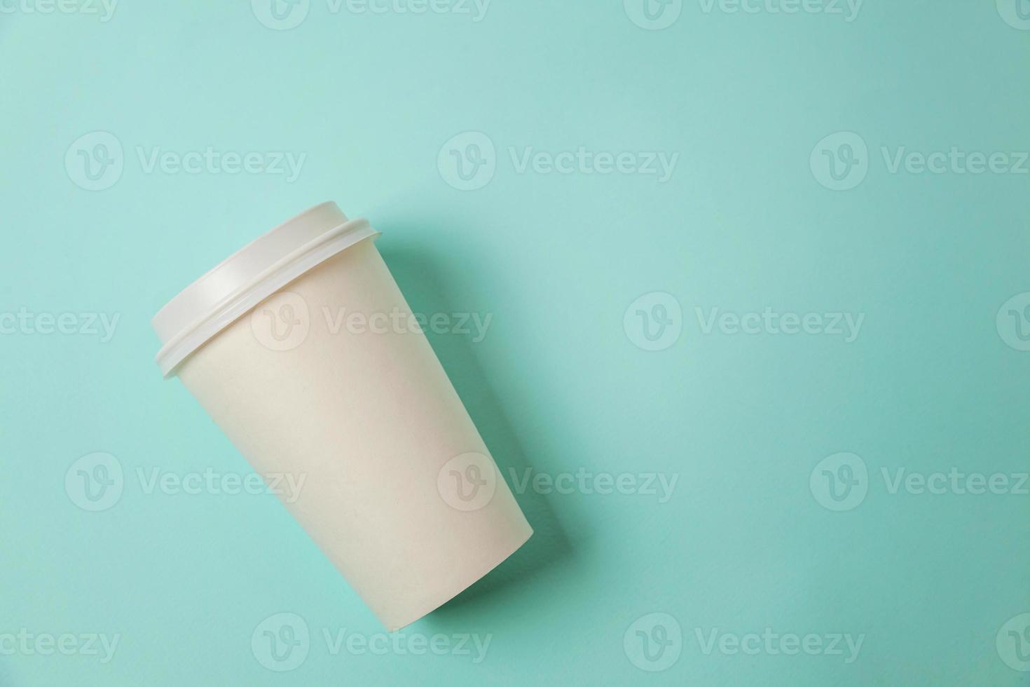 Simply flat lay design paper coffee cup on blue pastel colorful trendy background. Takeaway drink container. Good morning wake up awake concept. Template of drink mockup. Top view copy space. photo