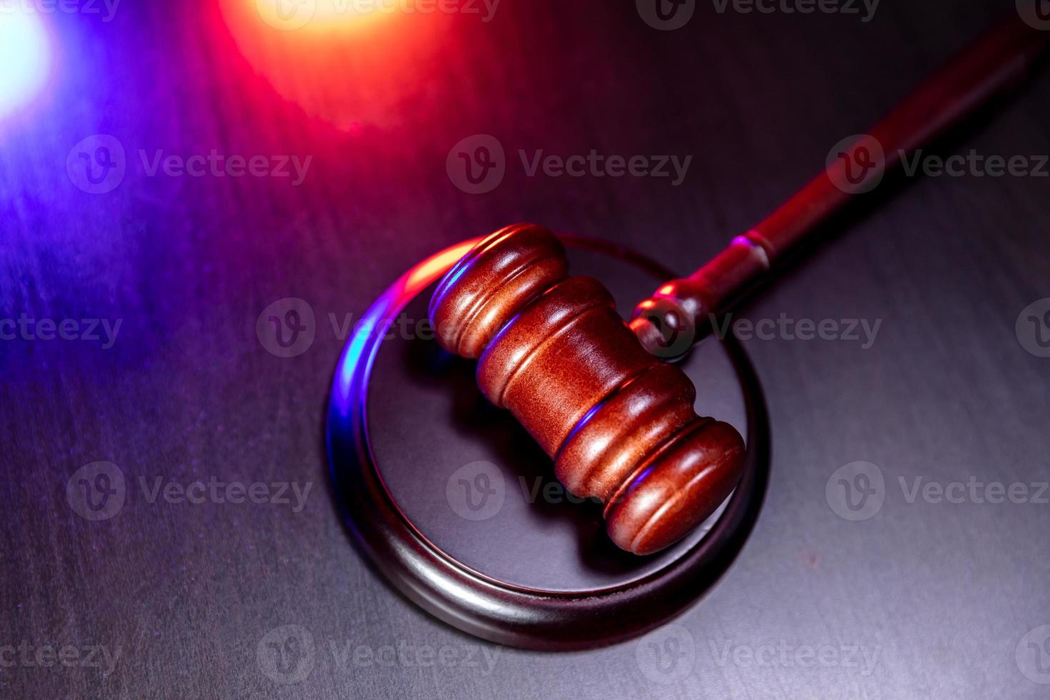 Law theme. Court of law trial in session. Judge gavel on wooden table in lawyer office or court session. Mallet of judge on dark background. Justice human rights concept. photo