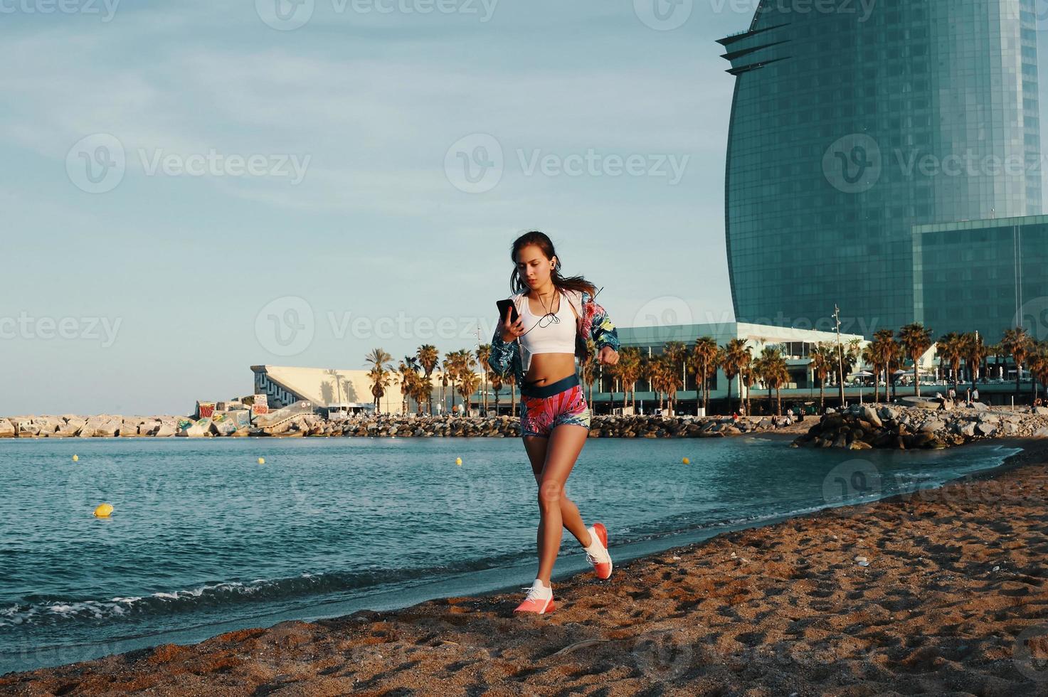 Power and balance. Full length of attractive young woman in sports clothing jogging while exercising outdoors photo