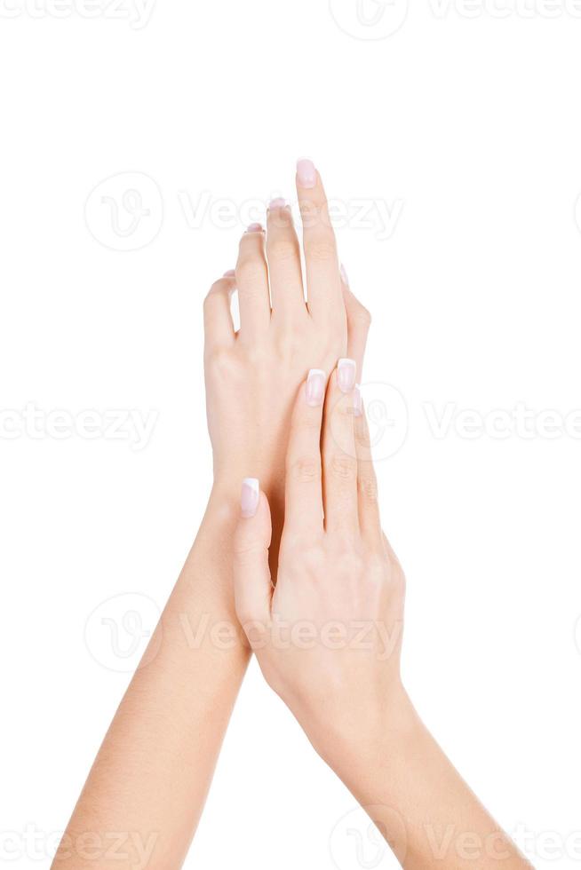 Sensual touch. Close-up of beautiful female hands isolated on white photo