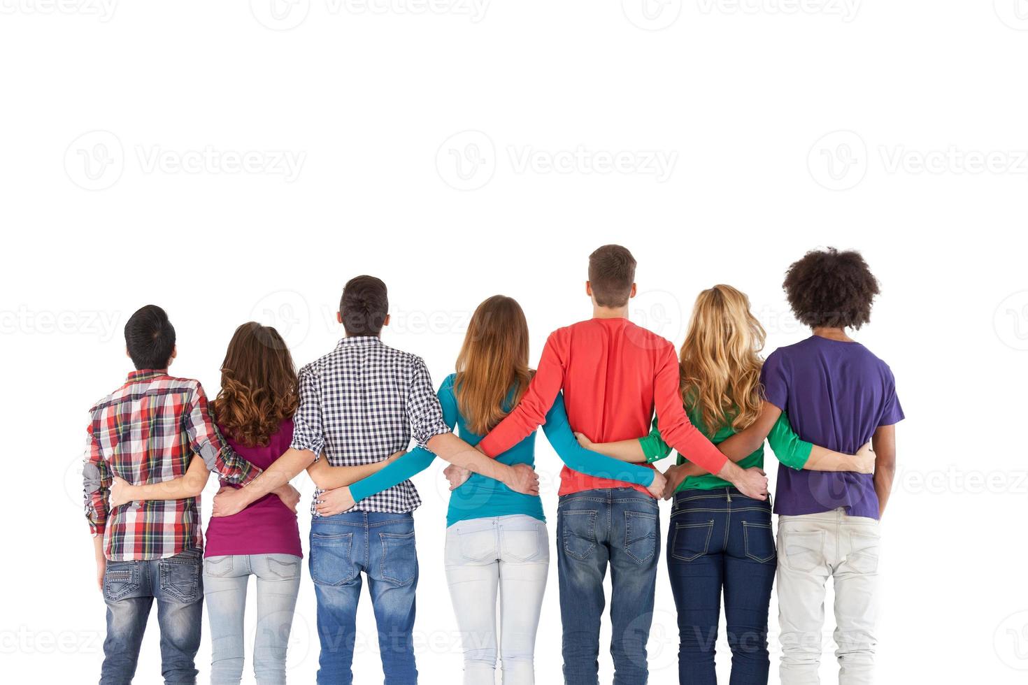 Team building. Rear view of multi-ethnic people standing close to each other while isolated on white photo