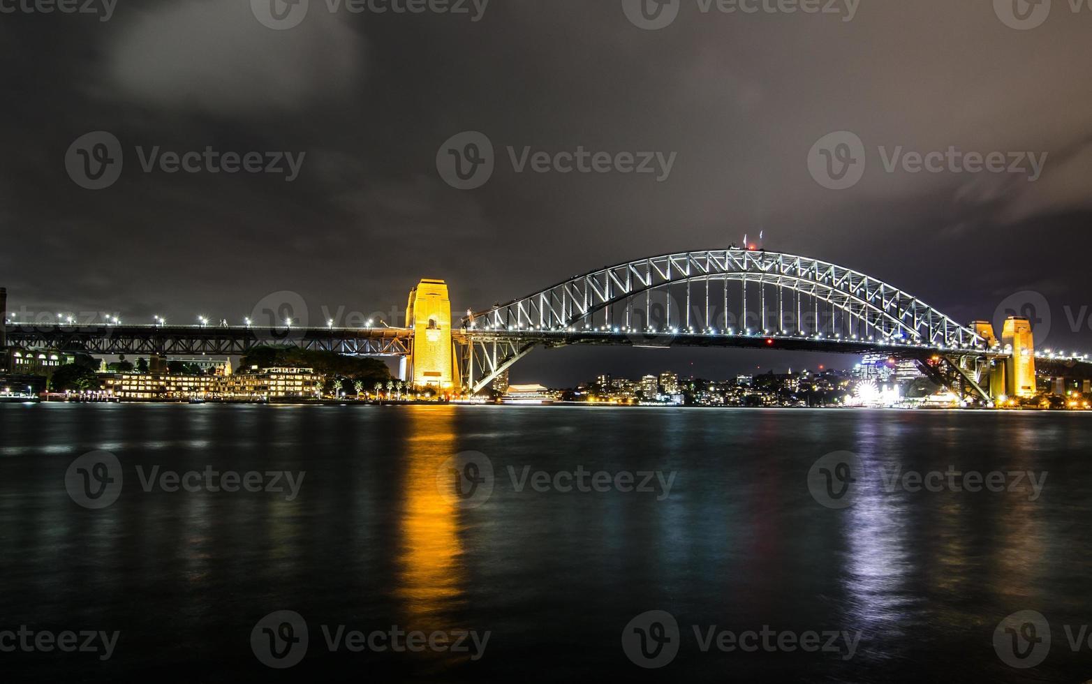 Night photography of Sydney Harbour Bridge in cloudy night. photo