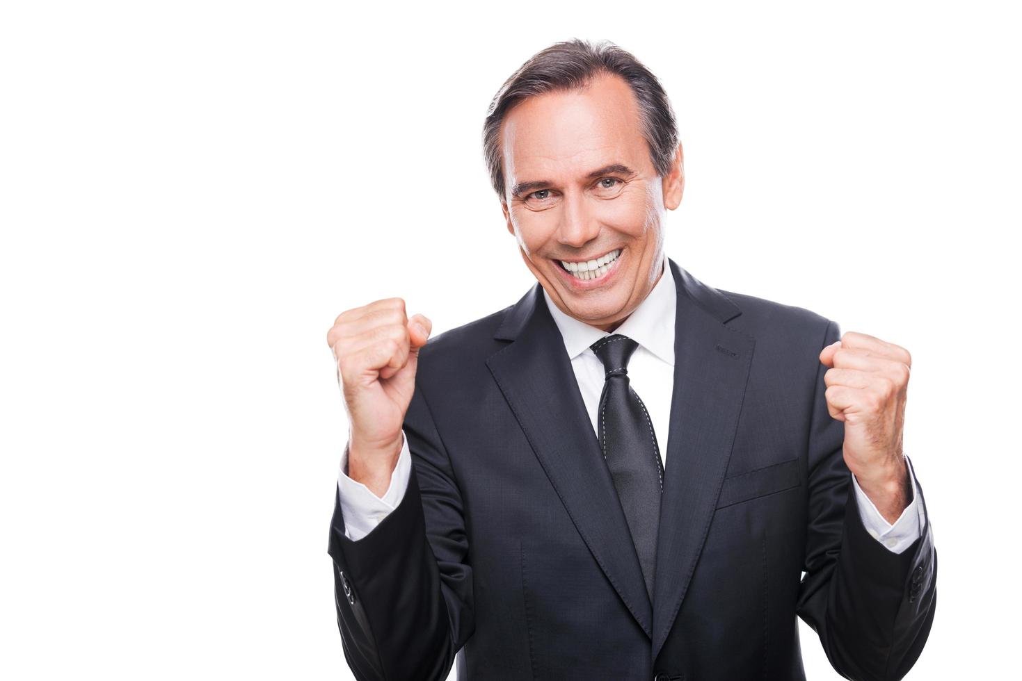 Successful businessman. Happy mature man in formalwear gesturing and smiling while standing isolated on white background photo