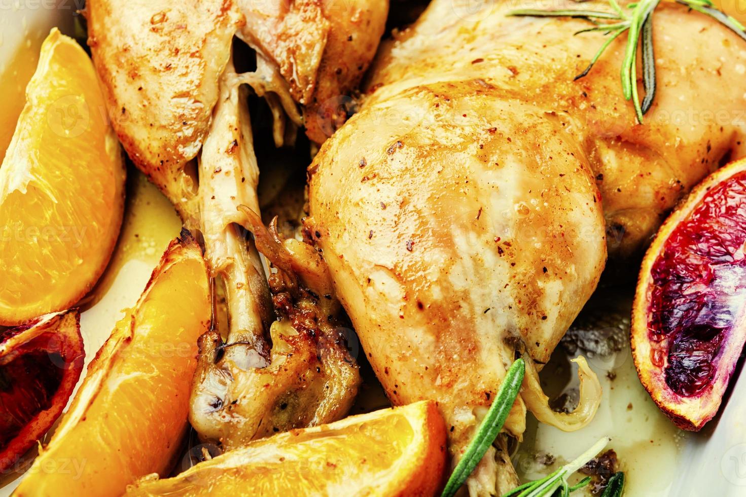 Roasted chicken legs with oranges photo