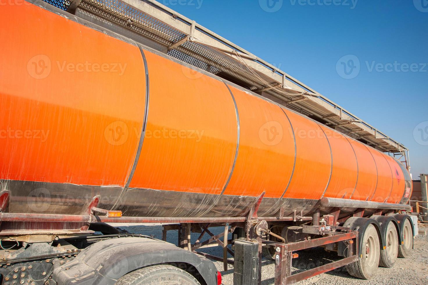 A closeup gas red tanker truck at an industrial construction site photo