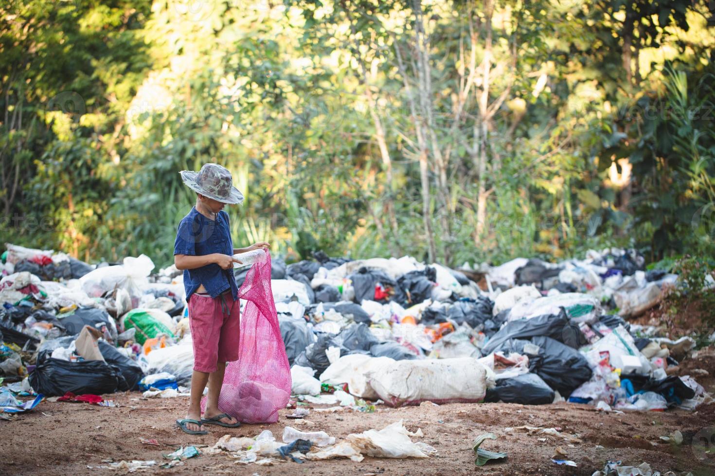 Poor children collect and sort waste for sale, concepts of poverty and the environment. photo