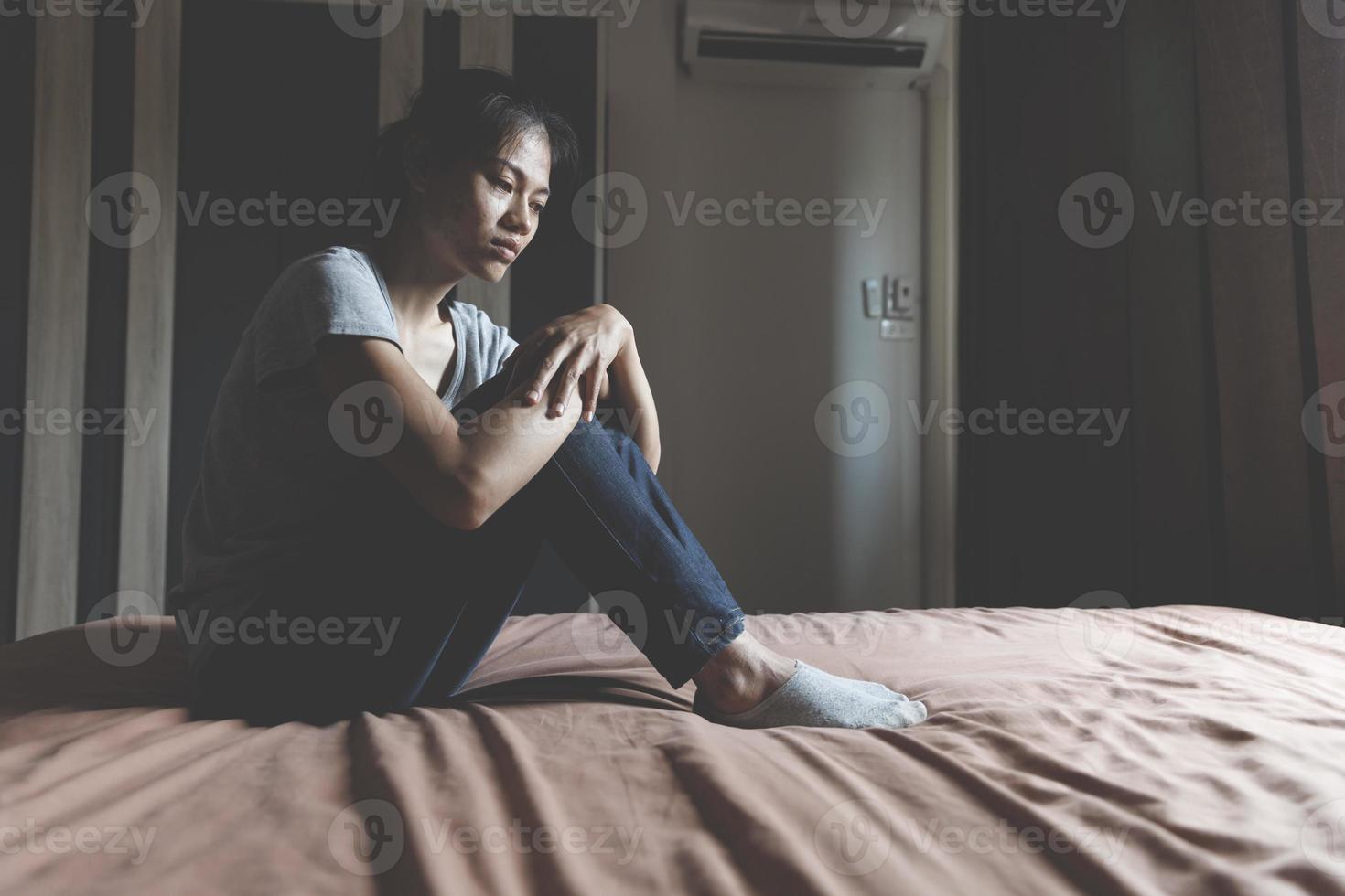 Asian woman sitting on the house area Feeling sad, tired and worried about depression, mental health problems and heartbreaking concept. photo