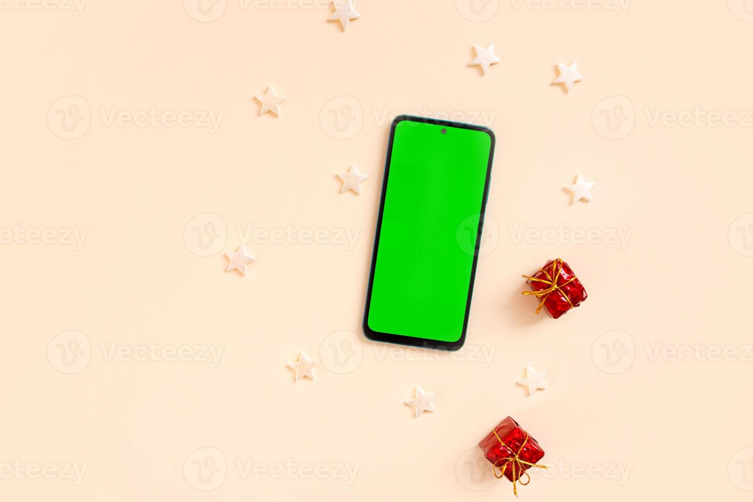 Chrismas flat lay with holiday decorations and phone  with green screen. Chroma key. photo