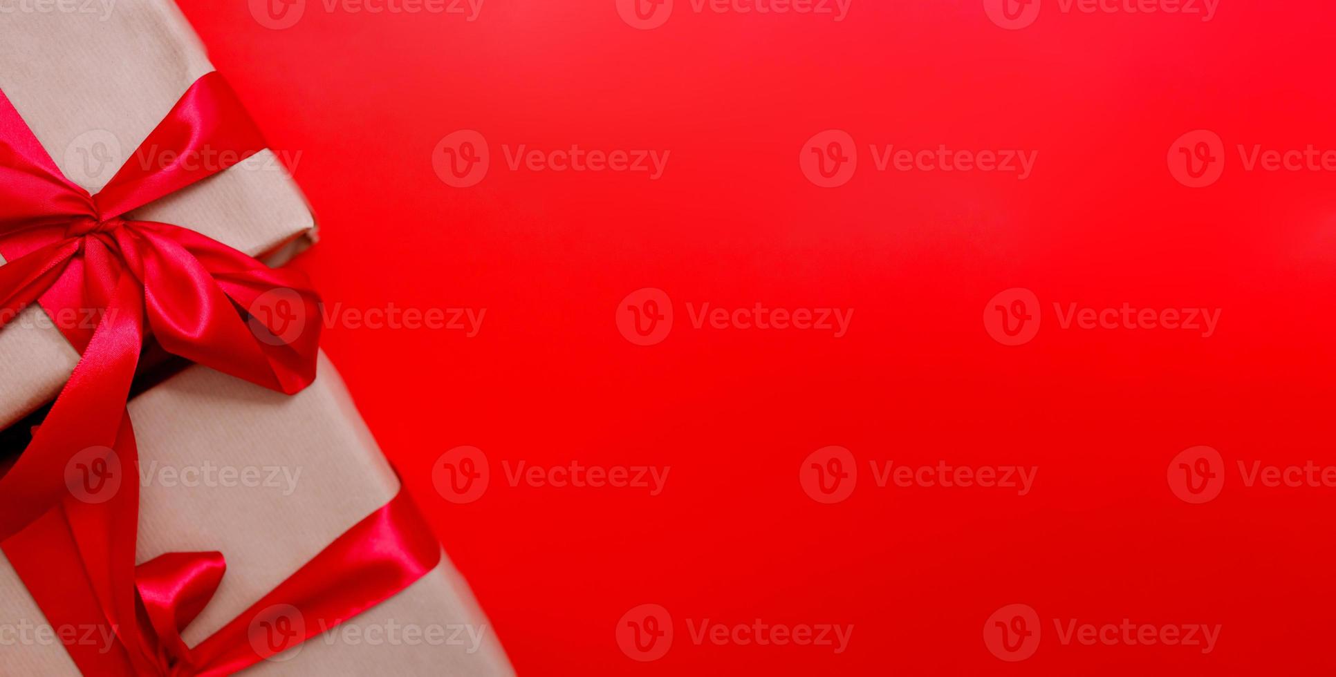 Christmas gift box on red background. Holiday concept. Presents on red backdrop photo