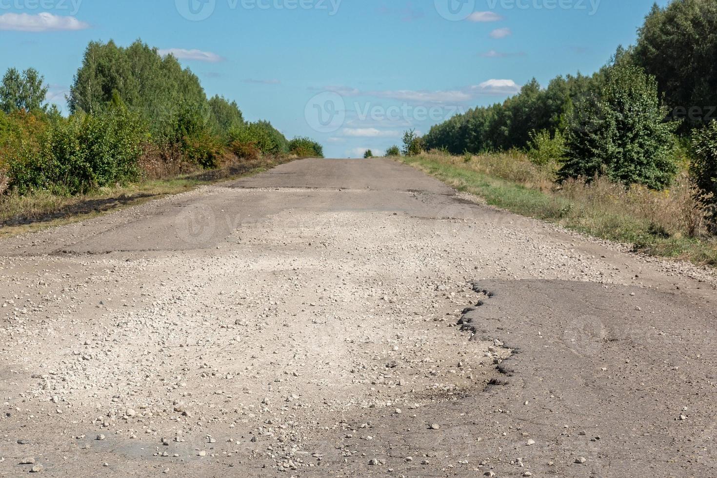 Broken asphalt road photo