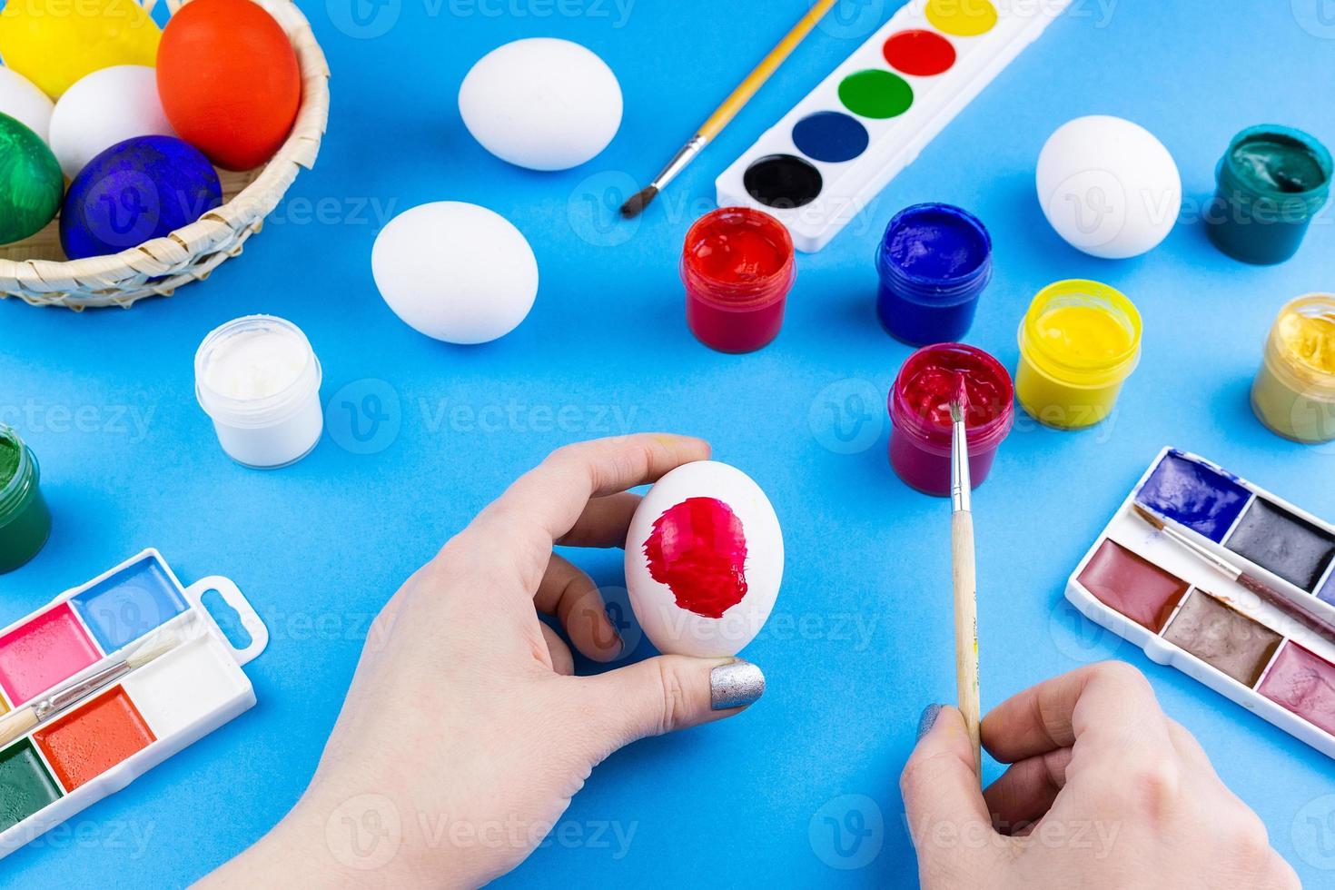 Girl paints eggs 13463980 Stock Photo at Vecteezy