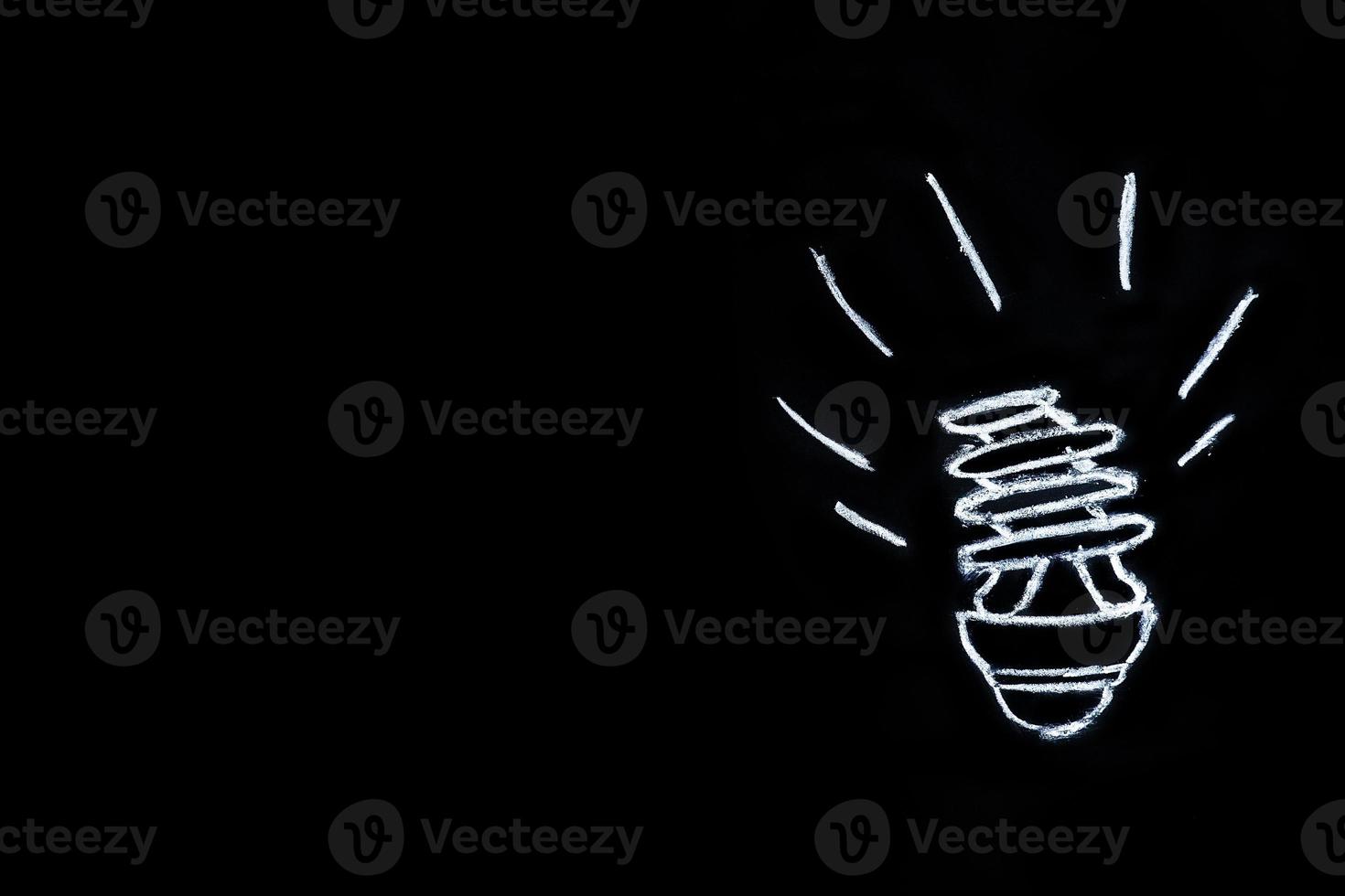 Light bulb on black background photo